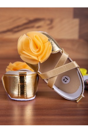 Baby set shoes decorated with flowers with a tassel
