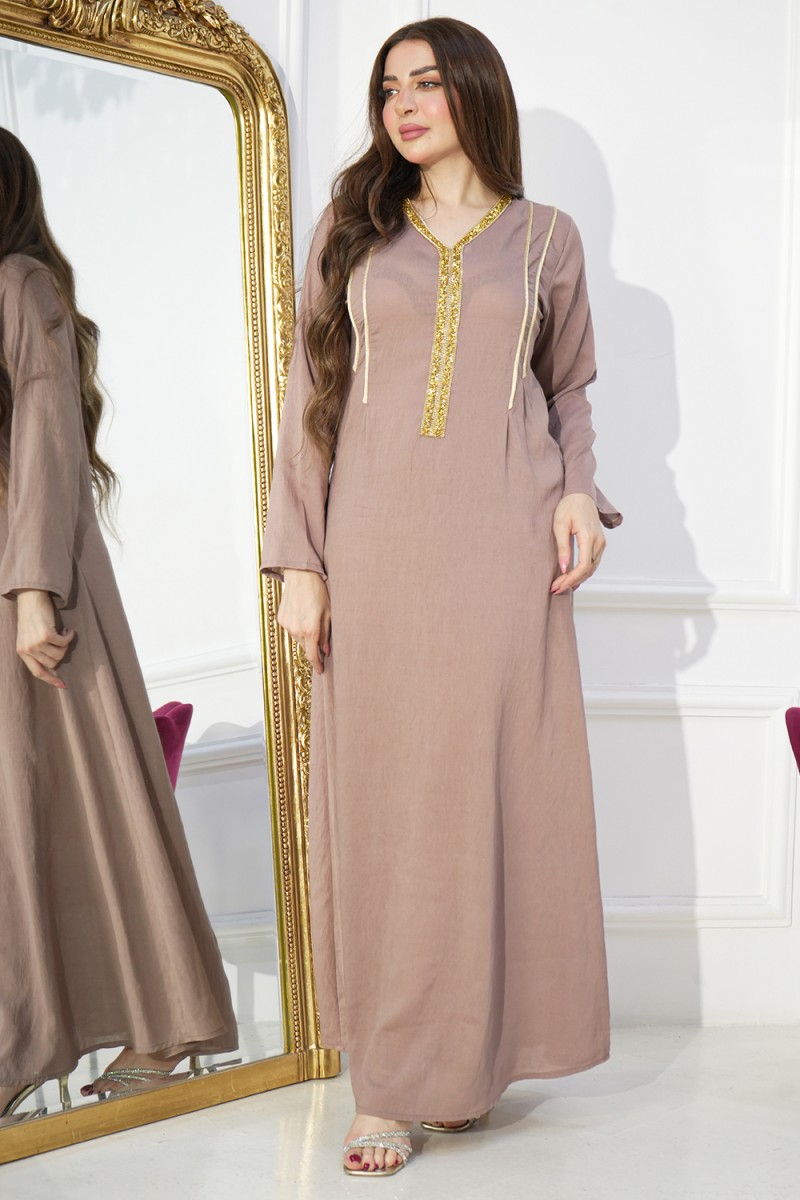 An elegant women's evening robe in a flesh color with wide sleeves and ...
