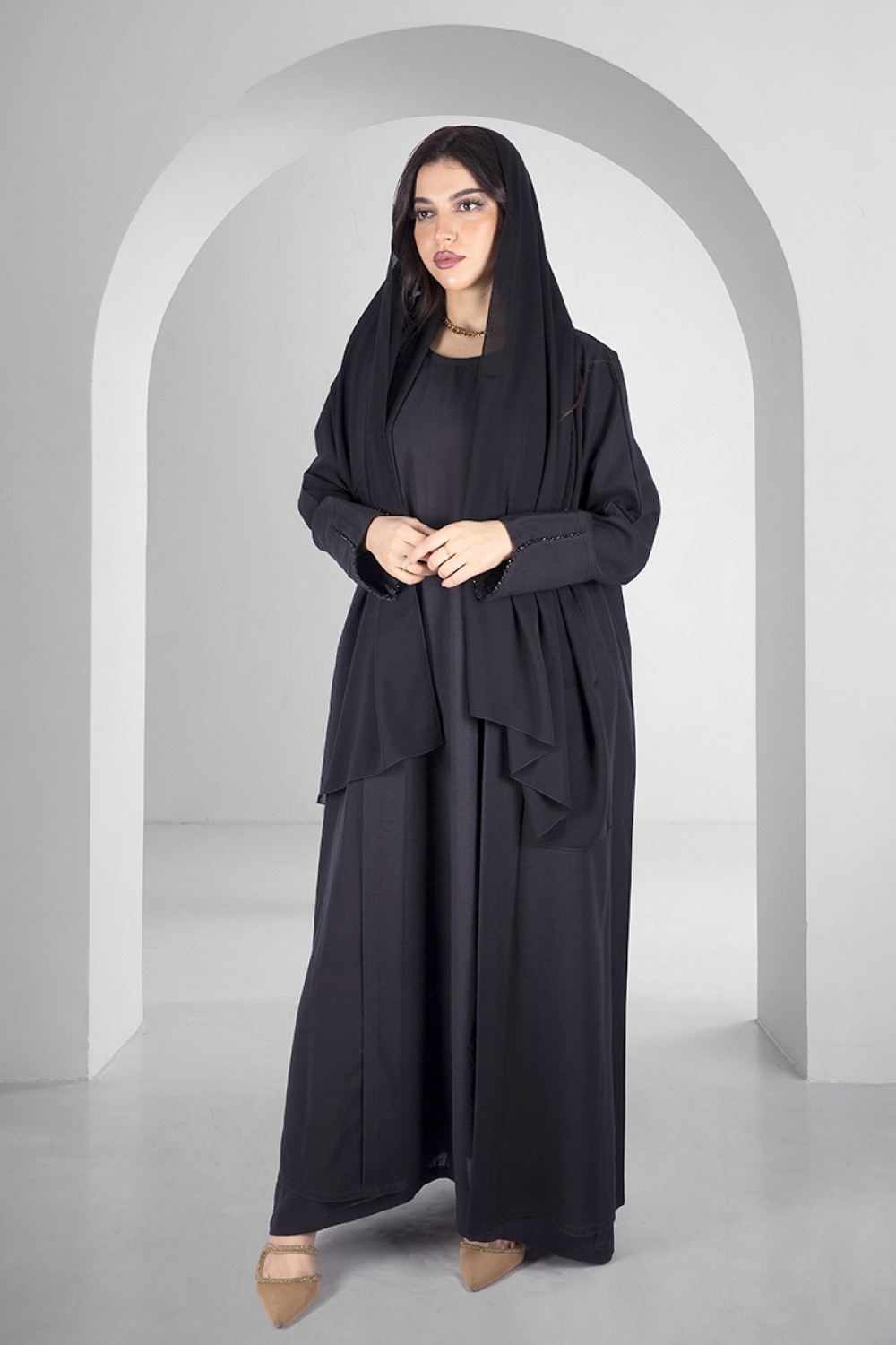 Elegant black abaya open at the front in the form of a bent layer with ...