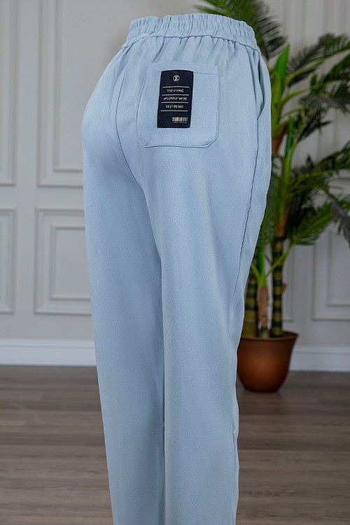 بنطلون شتوي أنيق قماش مخمل لون سماوي بجيوب من الجوانب و الخلف و خصر مطاط برباط من الأمام