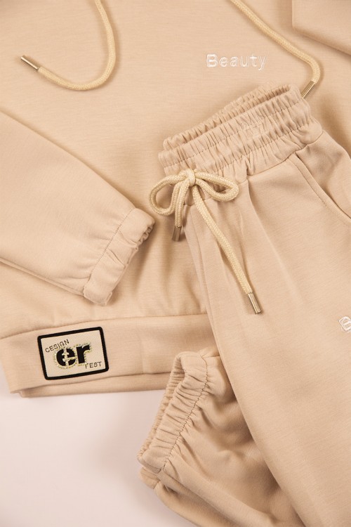 طقم بناتي شتوي قطعتين لون بيج بأكمام طويلة وقبعة متصلة مع بنطلون طويل بزم و رباط على الخصر