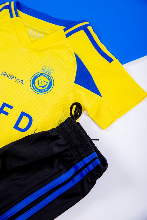 طقم ولادي رياضي قطعتين تيشيرت النصر لون أصفر بأكمام قصيرة و بنطلون طويل لون أسود مخطط باللون الأزرق من الجانبين بزم من الخصر و الأسفل