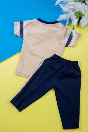 طقم ولادي قطعتين تيشيرت لون بيج مزين بكتابات و رسومات من الأمام مع بنطلون طويل لون كحلي 