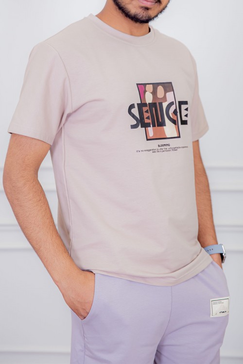 تيشيرت رجالي لون بيج مزين بكتابات و رسومات ملونة من الأمام