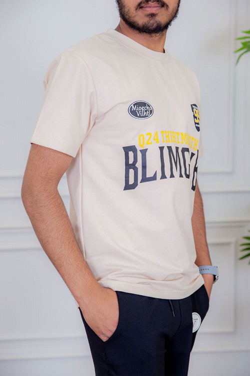 تيشيرت رجالي لون بيج مزين بكتابات و رسومات ملونة من الأمام