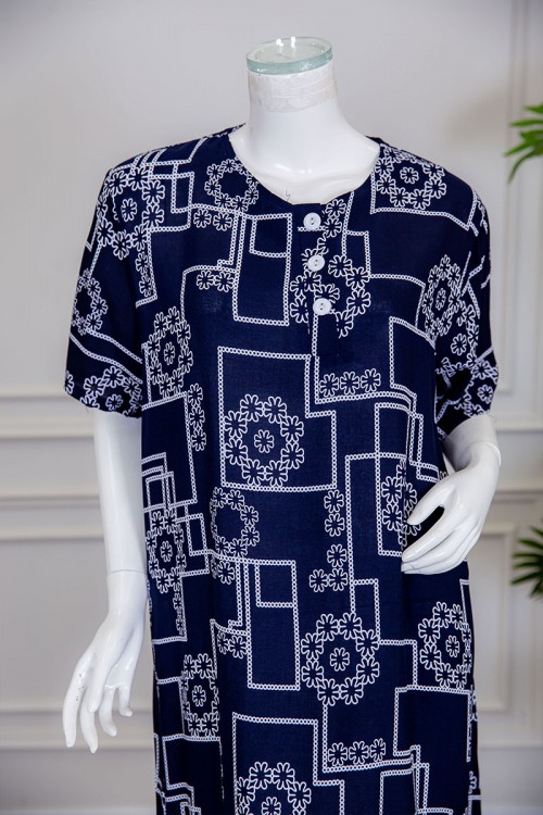 قميص نسائي طويل لون كحلي مزين برسومات مختلفة ياقة دائرية بأزرار من الأمام ذو أكمام قصيرة