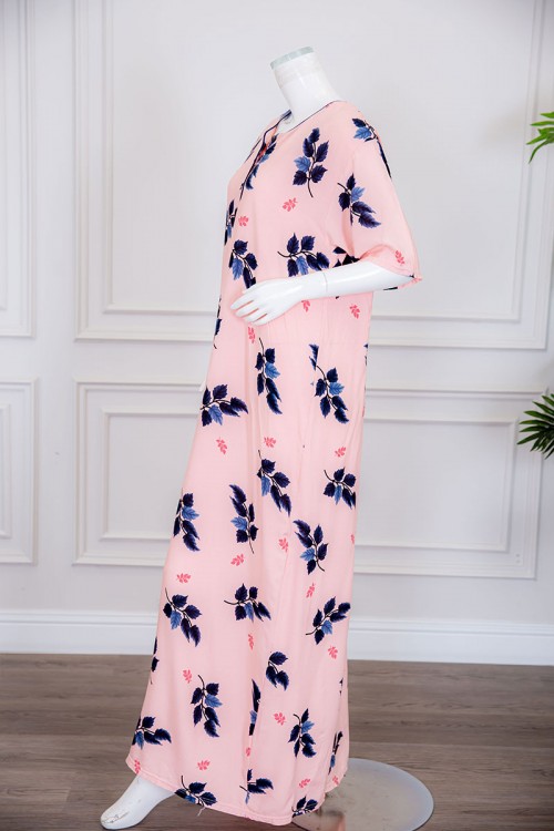 قميص نسائي طويل لون خربزي مزين برسومات أوراق الشجر ياقة دائرية بأزرار من الأمام ذو أكمام قصيرة