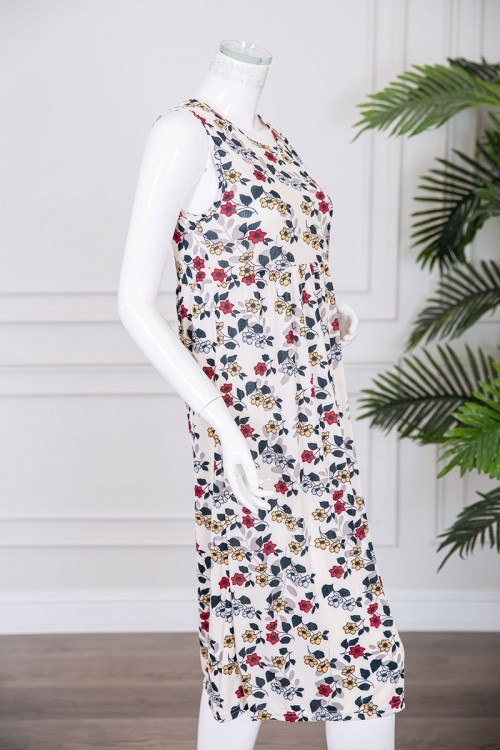 قميص نسائي قصير لون بيج مزين بالورود الملونة ياقة دائرية و بدون أكمام