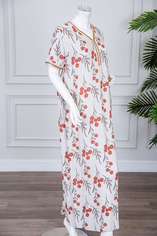 قميص نسائي طويل لون بيج فاتح مزين برسومات و بكلفة مطرزة في الياقة و الأكمام