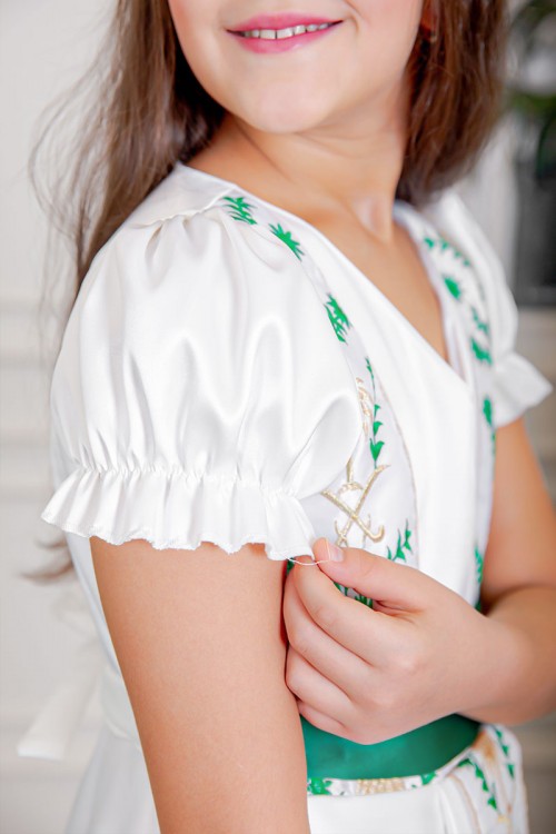 فستان بناتي لليوم الوطني لون أبيض مزين بتطريز تراثي بياقة قصة سبعة و أكمام قصيرة و رباط في الخصر