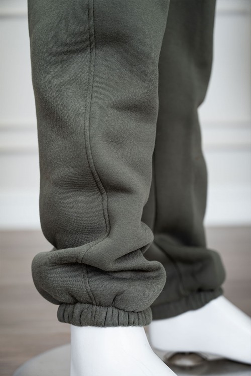 طقم قطعتين ولادي شتوي لون زيتي مزين بكتابات من الأمام و الخلف بلوزة ياقة دائرية بجيوب و أكمام طويلة و بنطلون طويل