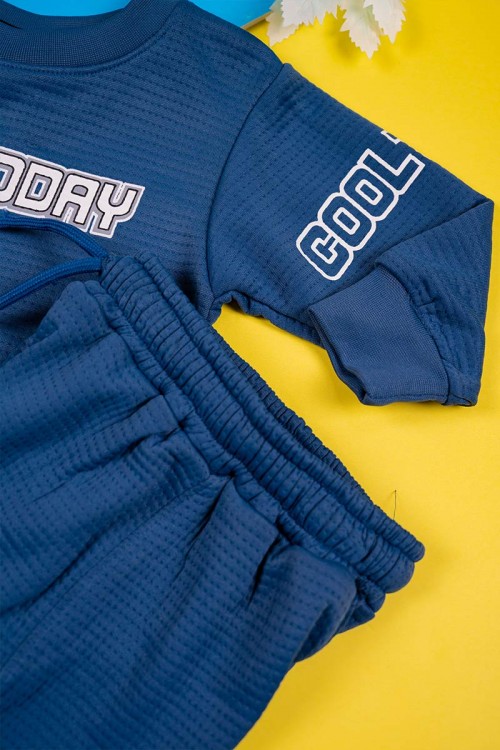 طقم قطعتين ولادي لون كحلي مزين بكتابات بأكمام طويلة مع بنطلون طويل برباط في الخصر و زم في الأطراف