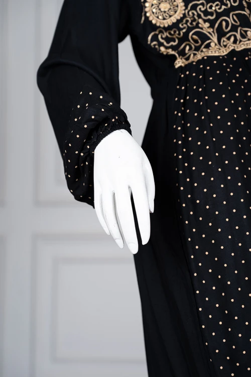 Long black women's *jalabiya* (oversized fit), featuring gold embroidery and patterns