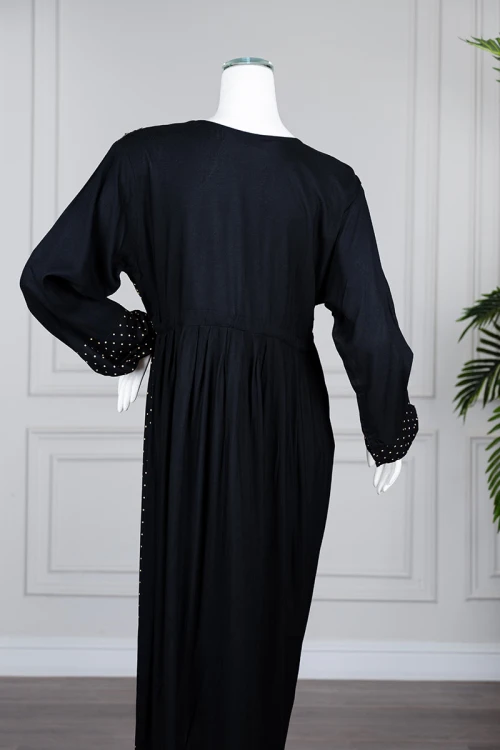 Long black women's *jalabiya* (oversized fit), featuring gold embroidery and patterns