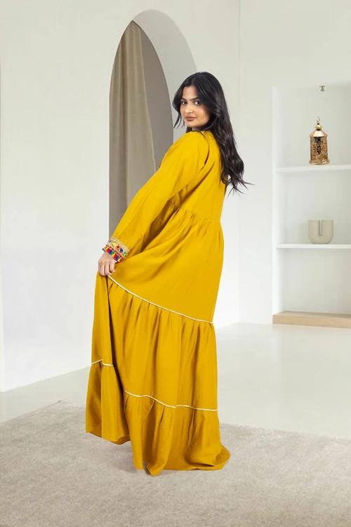 جلابية نسائي أنيقة فتحة الصدر شكل مربع بكسرات من الخصر وتزيين باللون الذهبي ودناديش ملونة في الصدر والأكمام