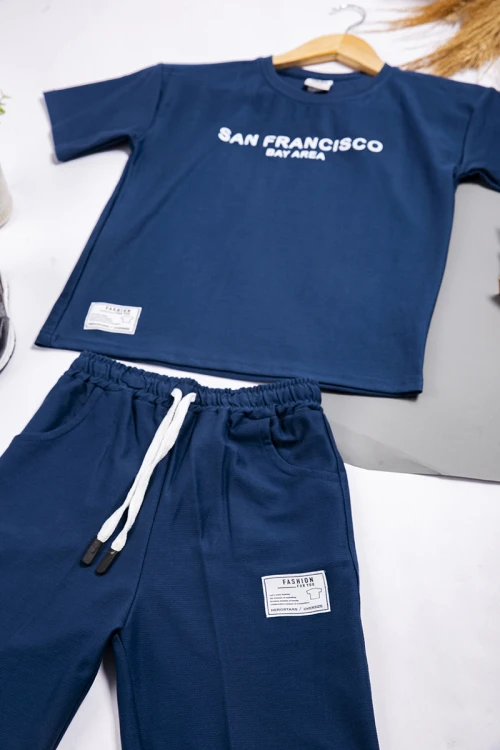 طقم ولادي أنيق قطعتين أكمام قصيرة و كتابة باللون الاسود وشعار من الأمام مع شورت بجيوب و رباط على الخصر