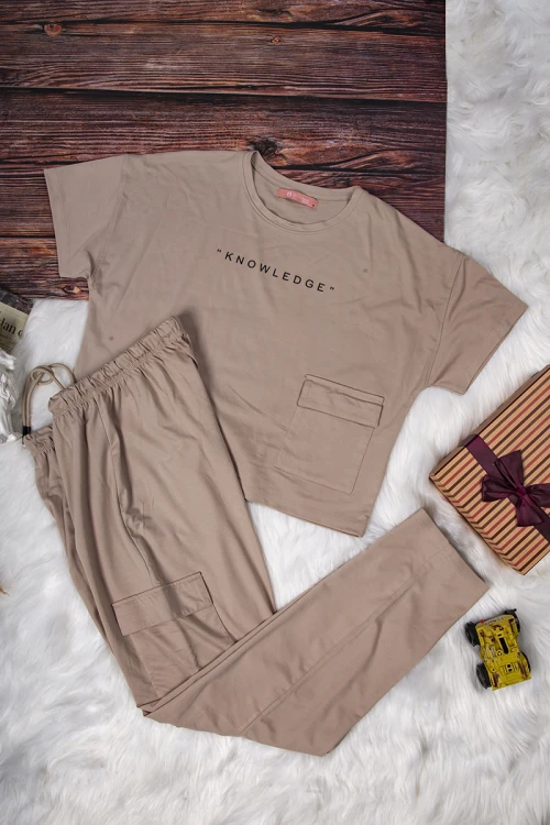 طقم نسائي أنيق قطعتين لون بني تي شيرت أكمام قصيرة بكتابة وجيوب من الأمام و بنطلون بجيوب ورباط على الخصر