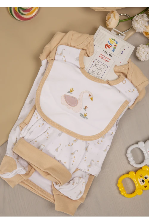 طقم أفرول مواليد 7 قطع لون مشمشي مزينة برسومات كرتونية