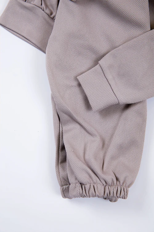 طقم بناتي شتوي قطعتين لون بيج بكتابات من الأمام و بقبعة رأس  و أكمام طويلة و رباط و زم من الخصر