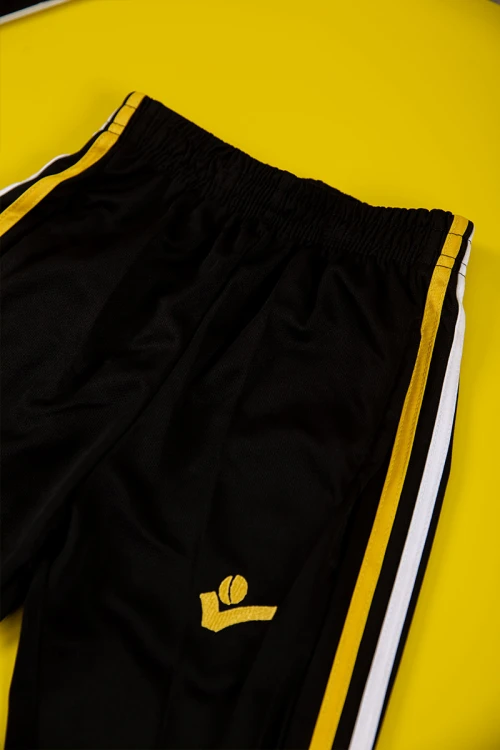 طقم ولادي رياضي قطعتين تيشيرت لون أحمر بأكمام قصيرة و بنطلون طويل لون أسود مخطط باللون الأبيض و الأصفر من الجانبين بزم من الخصر و الأسفل