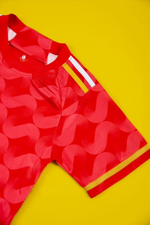 طقم ولادي رياضي قطعتين تيشيرت لون أحمر بأكمام قصيرة و بنطلون طويل لون أسود مخطط باللون الأبيض و الأصفر من الجانبين بزم من الخصر و الأسفل