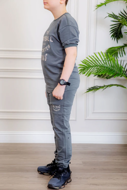 ترنج ولادي قطعتين لون رمادي تيشيرت بكتابات من الأمام و الخلف و بنطلون بجيوب من الجانبين و الخلف