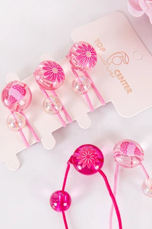 ربطة شعر 6 حبات مزيج من اللون الوردي الفاتح و الغامق على شكل كرات شفافة لامعة مزينة بأشكال مختلفة 