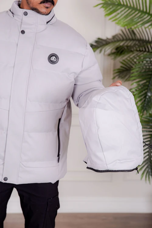 جاكيت رجالي شتوي منفوخ لون رمادي فاتح بقبعة رأس منفصلة قابلة للتركيب و أكمام طويلة و بجيوب وسحاب من الأمام