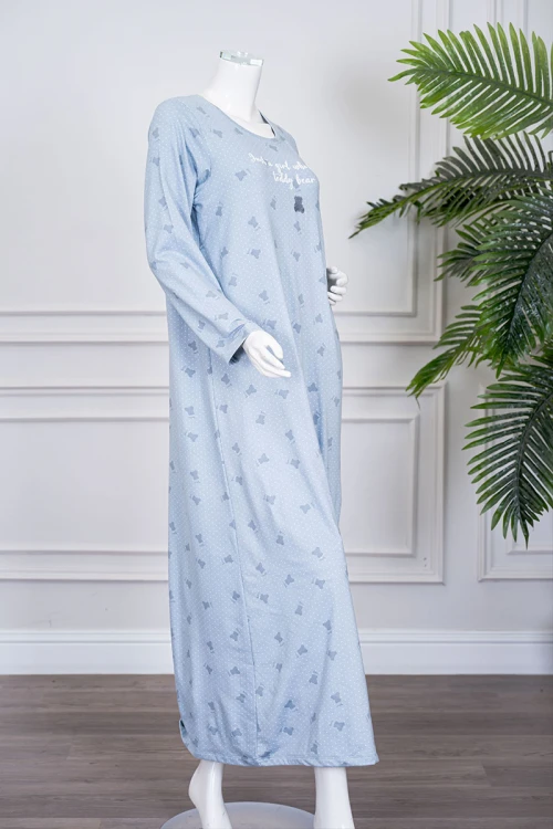 قميص نسائي طويل لون سماوي مزين بكتابات ورسومات ياقة دائرية و بأكمام طويلة