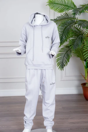 طقم بناتي شتوي قطعتين لون رمادي فاتح هودي بقبعة متصلة برباط و بجيوب الكنغر و أكمام طويلة مع بنطلون طويل برباط في الخصر و جيوب من الجانبين