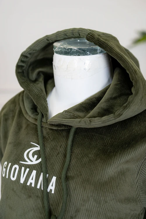 طقم بناتي شتوي قطعتين لون زيتي هودي بقبعة متصلة برباط و أكمام طويلة مزين بكتابات باللون الأبيض مع بنطلون طويل برباط في الخصر و جيوب من الجانبين