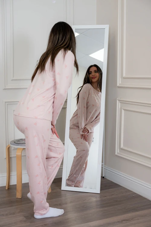 بيجاما نسائية قطعتين لون وردي مزينة بكتابات ورسومات ياقة دائرية و بأكمام طويلة مع بنطلون طويل برباط في الخصر