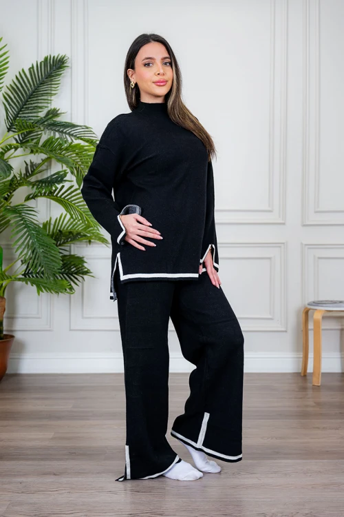 طقم تريكو نسائي شتوي قطعتين لون أسود مزين من الأطراف باللون الأبيض ياقة عالية مع بنطلون طويل