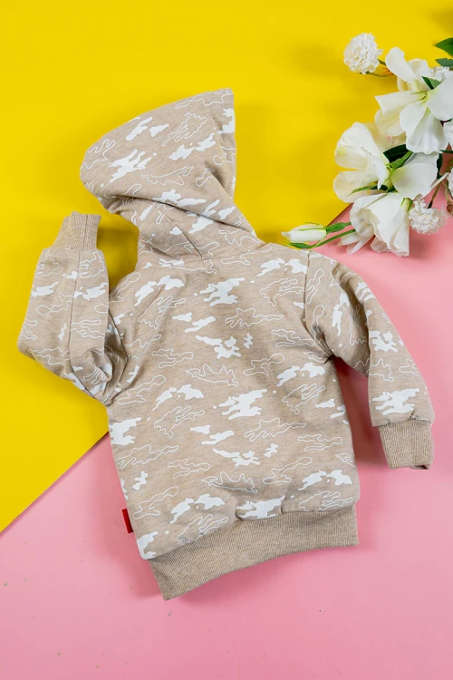 بلوفر أطفال شتوي مبطن لون بيج مزين برسومات باللون الأبيض قبعة متصلة برباط و بسحاب و جيوب من الأمام و أكمام طويلة