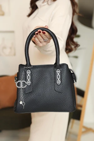 شنطة نسائية لون أسود مزينة باكسسوارات فضية 