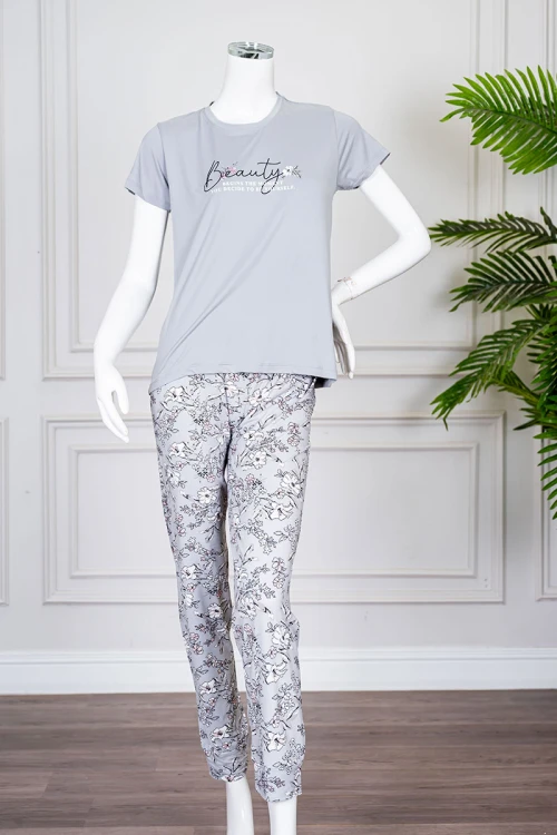 بيجاما نسائية قطعتين لون رمادي بلوزة بياقة دائرية مزينة برسومات و كتابات من الأمام بأكمام قصيرة مع بنطلون مشجر