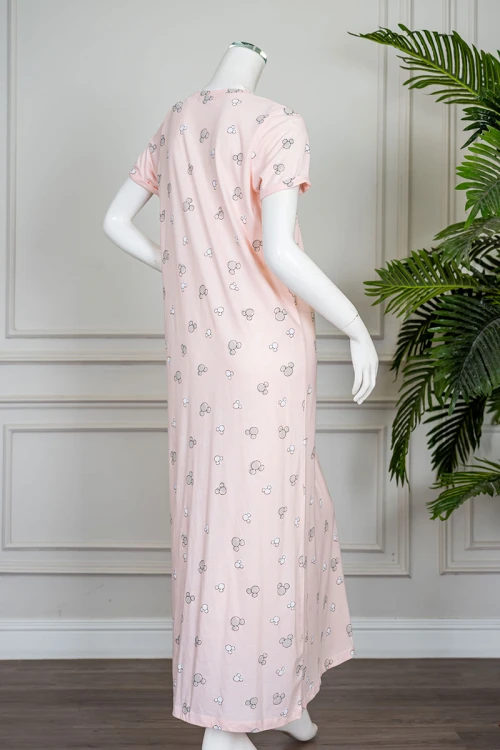 قميص نسائي طويل لون خربزي مزين بكتابات و رسومات ياقة دائرية و بأكمام قصيرة