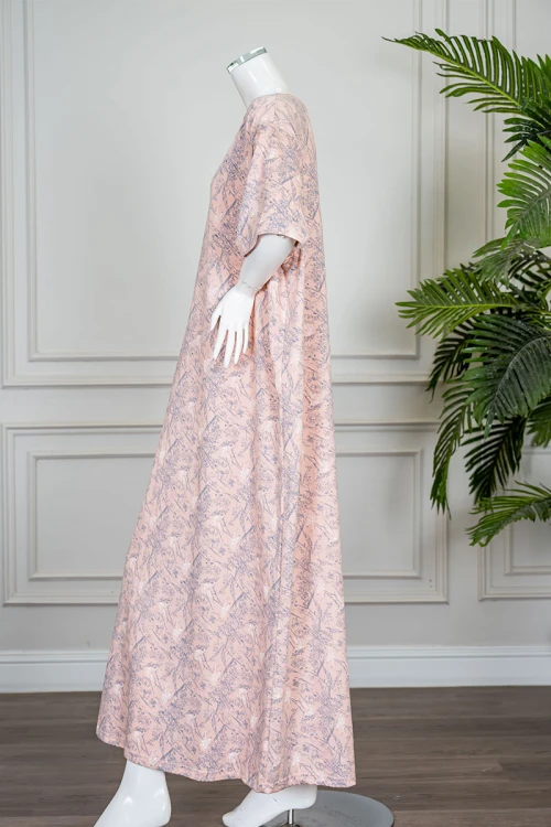 قميص نسائي طويل لون خربزي مزين برسومات ياقة دائرية و بأكمام قصيرة