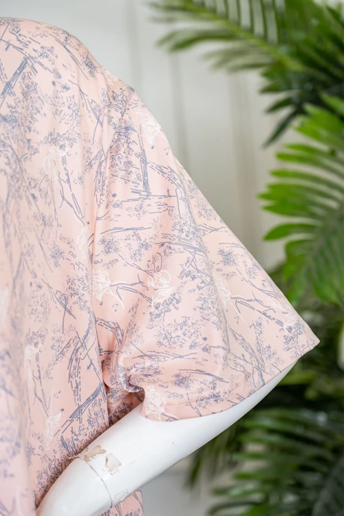 قميص نسائي طويل لون خربزي مزين برسومات ياقة دائرية و بأكمام قصيرة