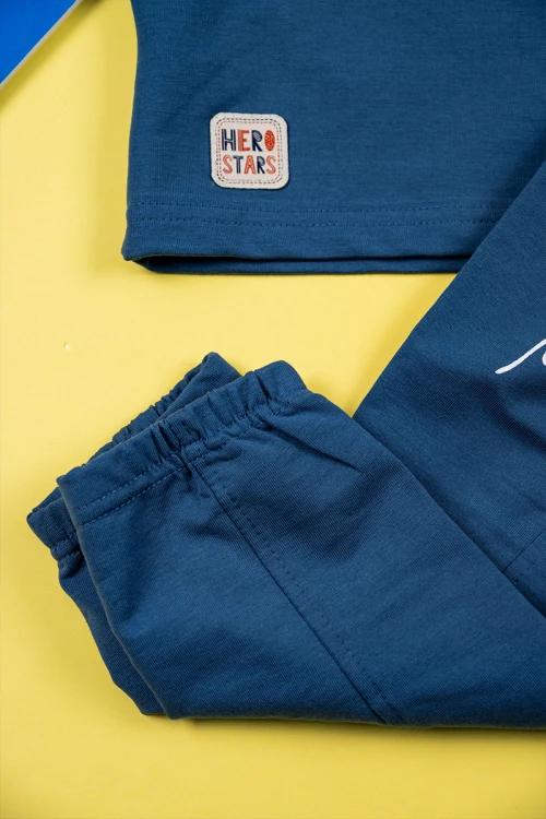 طقم ولادي قطعتين لون كحلي تيشيرت بكتابات من الأمام مع بنطلون طويل برباط في الوسط و زم في الأسفل و جيوب من الجانبين