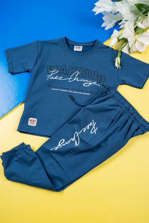 طقم ولادي قطعتين لون كحلي تيشيرت بكتابات من الأمام مع بنطلون طويل برباط في الوسط و زم في الأسفل و جيوب من الجانبين