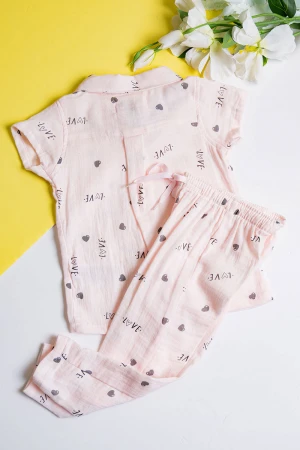 بيجاما بناتي قطعتين لون خربزي مزين برسومات و كتابات تيشيرت بياقة مطوية و أزرار من الأمام مع بنطلون طويل برباط في الخصر  