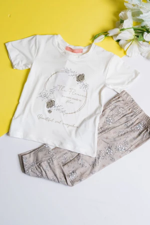 بيجاما بناتي قطعتين تيشيرت لون أبيض مزين برسومات و كتابات من الأمام مع بنطلون طويل لون بيج مشجر 