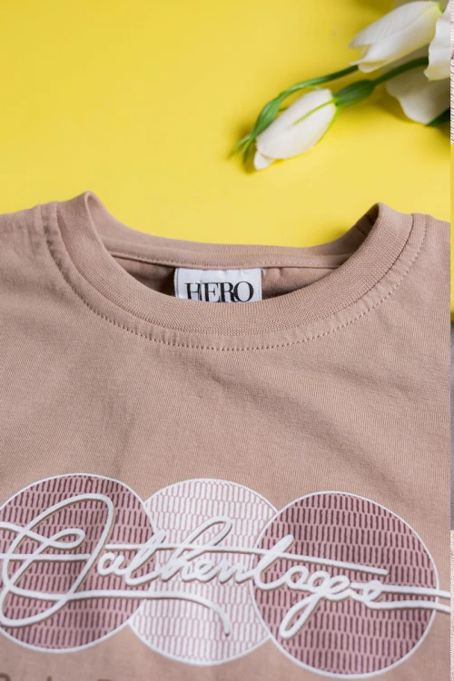 طقم ولادي قطعتين لون بيج تيشيرت مزين بكتابات و رسومات من الأمام مع بنطلون طويل بجيوب و رباط في الخصر