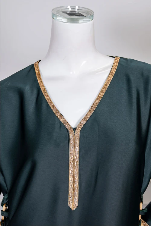 جلابية نسائية لون زيتي ياقة بقصة سبعة مزينة بكلفة مطرزة باللون الذهبي من الياقة و أطراف الأكمام و برباط من الجانبين